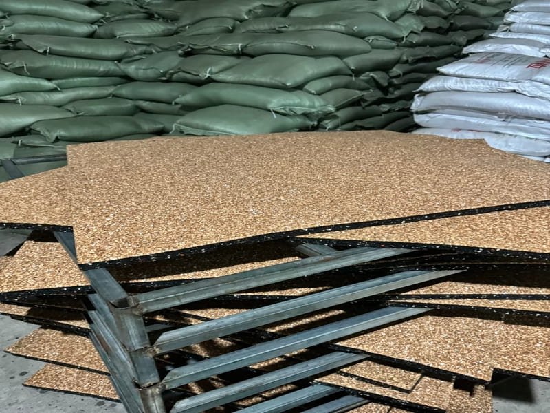 A commercial gym with heavy-duty black rubber flooring rolls.